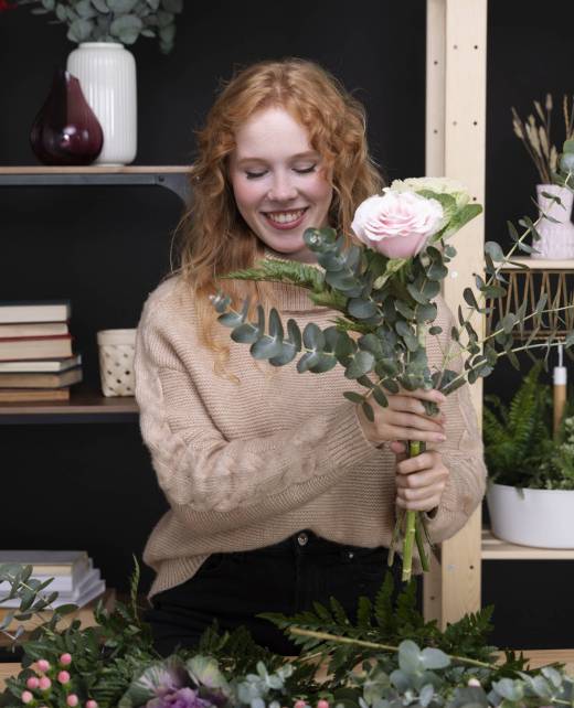 smiley-woman-flowers-shop-medium-shot